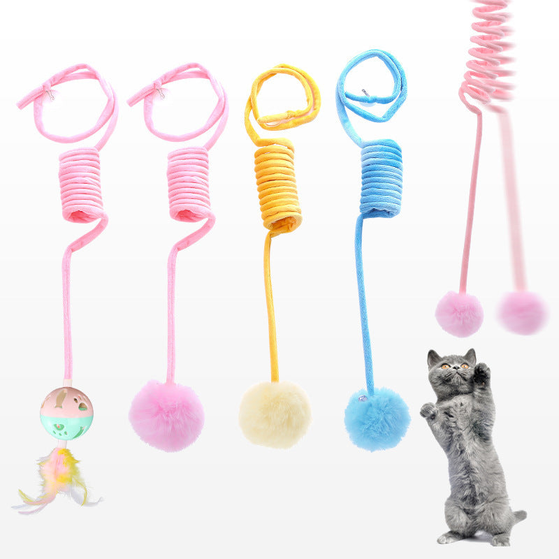 Multiple spring rabbit hair ball cat toys in pink, yellow, and blue colors with kitten pawing