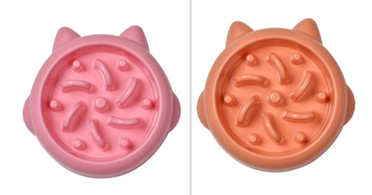Side-by-side top view comparison of pink and orange slow feeder bowls