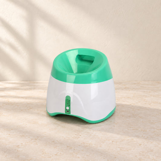 Rear view of green automatic dog ball launcher with loading hopper and controls