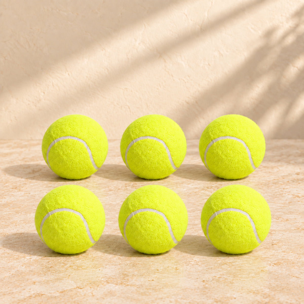Six yellow miniature tennis balls included with the automatic dog ball launcher