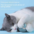 Load image into Gallery viewer, Gray and white cat biting and holding a blue silicone automatic cat toy ball, emphasizing safe bite-resistant material
