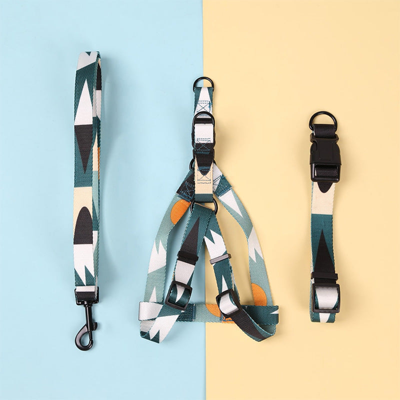 Green, blue, and orange geometric patterned dog collar laid flat on white background
