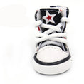 Load image into Gallery viewer, Close-up front view of a black and white star print dog shoe with white laces
