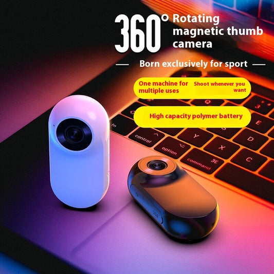 White and black rotating magnetic thumb-sized cameras on laptop keyboard