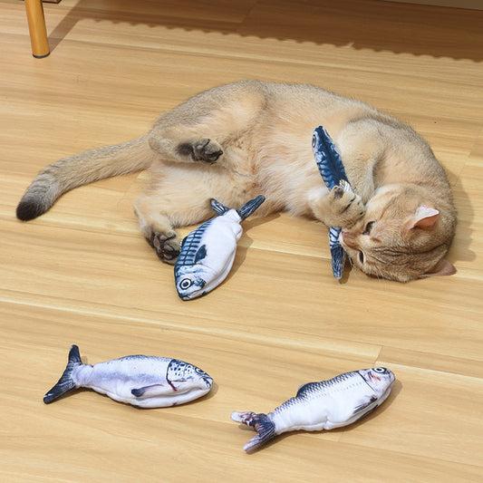 Cat playing with multiple soft fabric fish cat toys on wooden floor