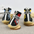 Load image into Gallery viewer, Three breathable reflective dog boots in blue, red, and yellow colors displayed upright on wooden coasters
