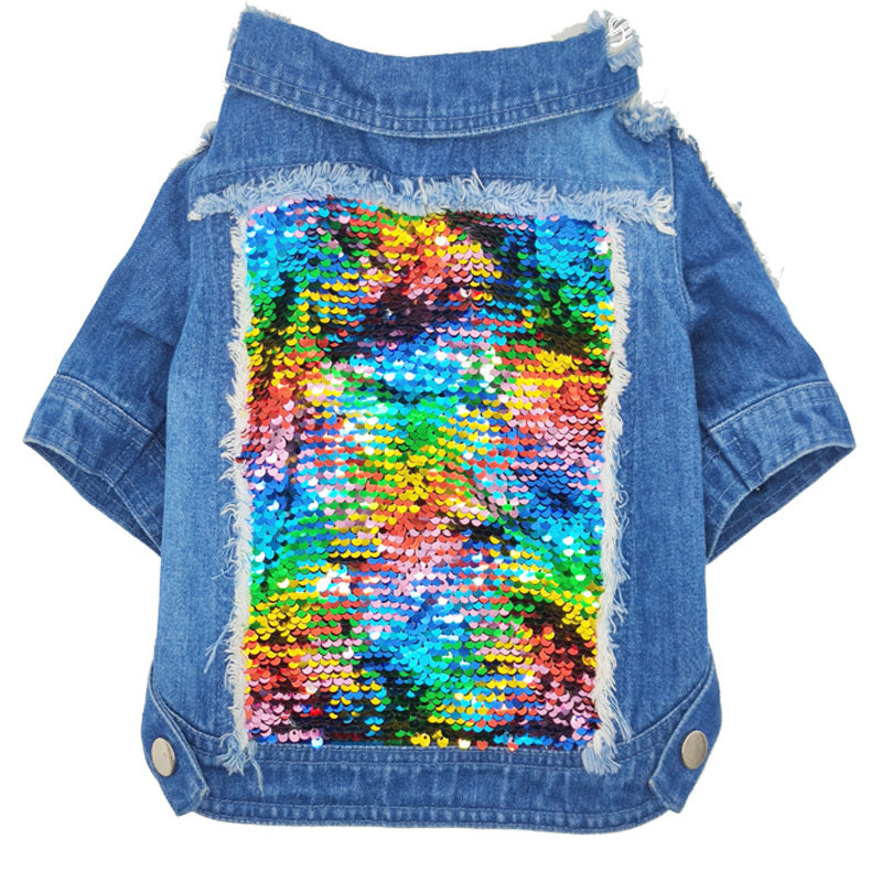 Flat lay of blue denim dog jacket displaying colorful sequin patch on the back with frayed detailing