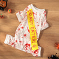Charger l'image dans la visionneuse de la galerie, Flat lay of white blood splatter dog outfit with yellow sash surrounded by small Halloween pumpkin decorations
