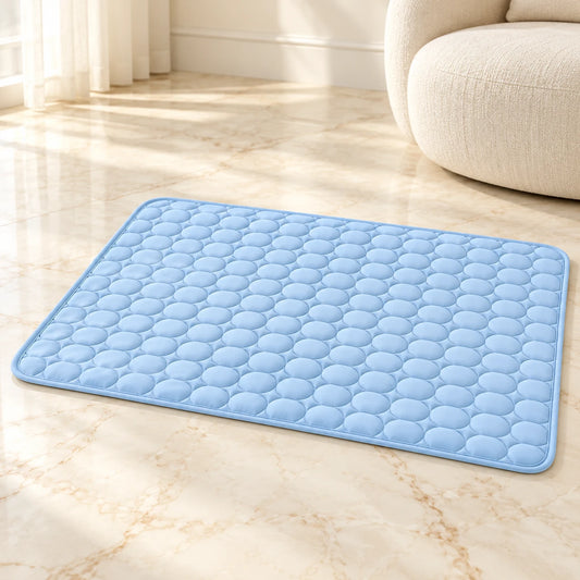 Blue quilted cooling pet mat with rounded corners on cream marble