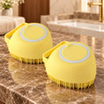 Load image into Gallery viewer, Two yellow smooth-bodied silicone pet bath brushes on brown marble
