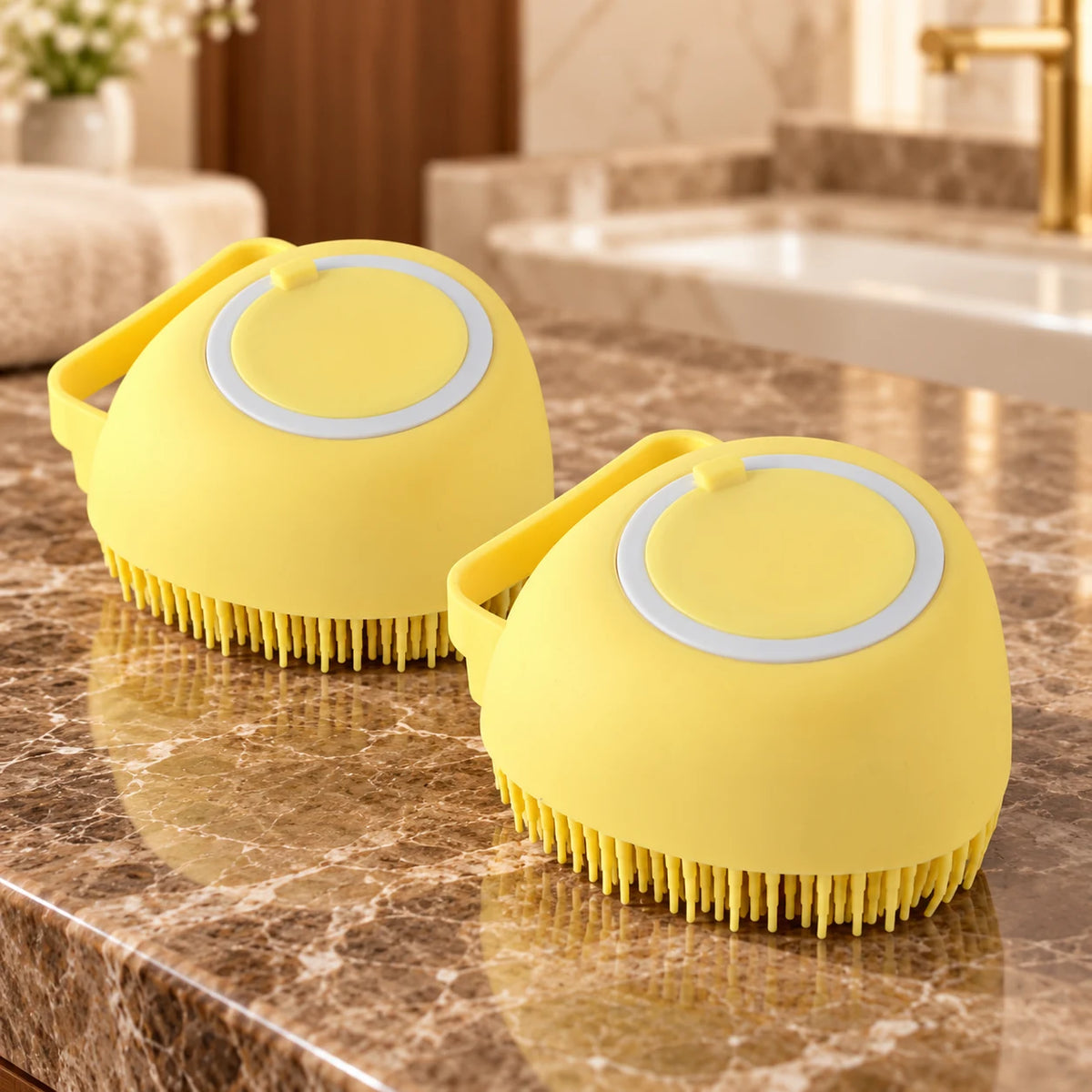 Two yellow smooth-bodied silicone pet bath brushes on brown marble