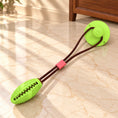 Charger l'image dans la visionneuse de la galerie, Lime green oval dog tug toy with brown cord and suction cup on light ivory-beige marble
