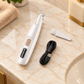 Load image into Gallery viewer, White pet trimmer with cleaning brush and USB cable on light ivory-beige marble
