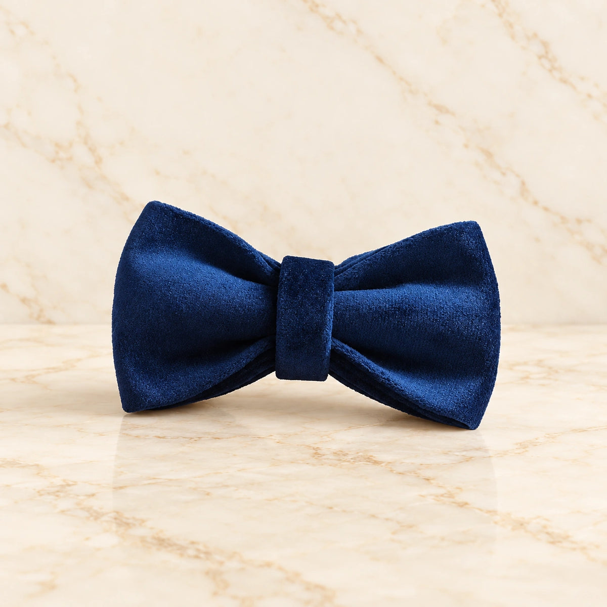 Navy velvet bow only with silver hardware on light ivory-beige marble.