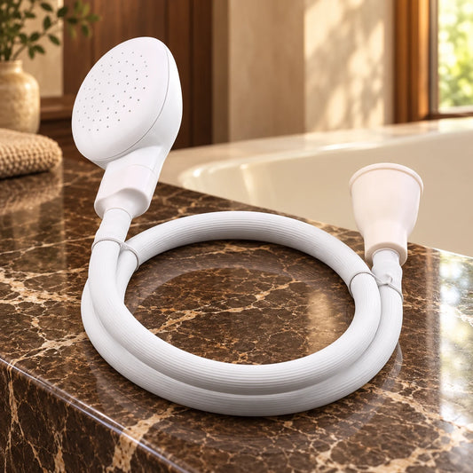 White pet shower head with flexible hose and tap connector on a brown marble bath surround.