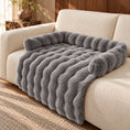 Load image into Gallery viewer, Dark gray plush sofa pet mat with raised bolsters and draped front on a cream sofa
