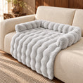 Load image into Gallery viewer, Light gray plush sofa pet mat with raised bolsters and draped front on a cream sofa

