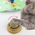 Load image into Gallery viewer, Gray cat pawing at catnip ball toy in brown base with arrow showing rotary motion
