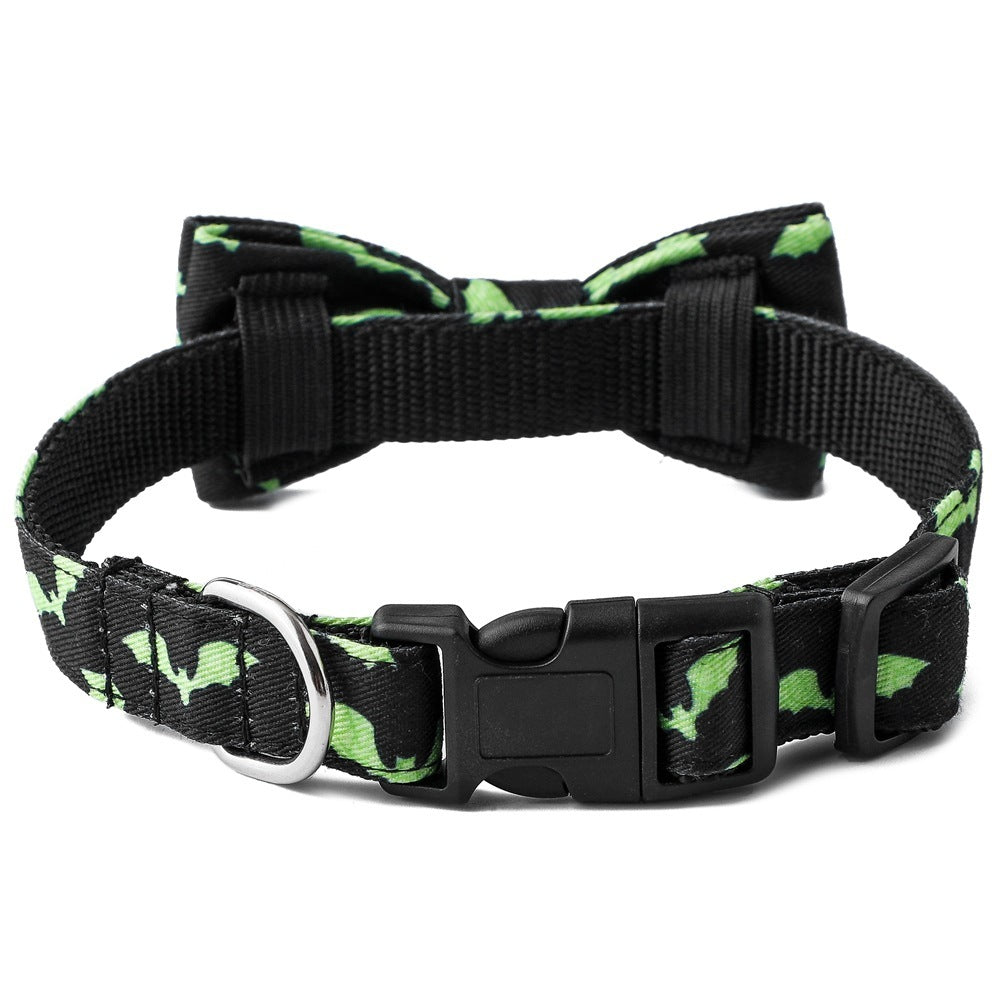 Close-up of green bat pattern pet collar with bow tie and black plastic buckle