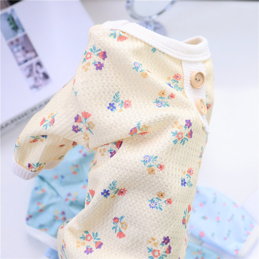 Close-up of yellow floral dog pajamas showing mesh texture and button accents