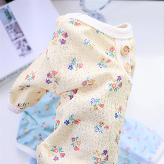 Close-up of yellow floral dog pajamas showing mesh texture and button accents