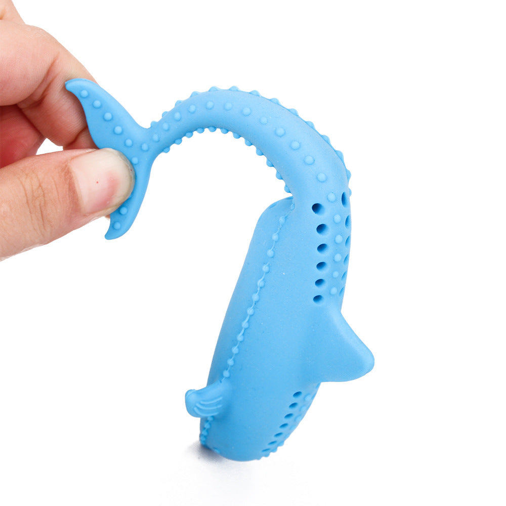 Hand holding and bending the blue fish-shaped silicone cat molar stick demonstrating flexible material