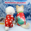 Charger l'image dans la visionneuse de la galerie, Two small dogs wearing colorful festive holiday pajamas sitting side by side facing a snowy winter backdrop, one with red pajamas featuring Christmas trees and the other with green and red pajamas decorated with Santa faces and candy canes
