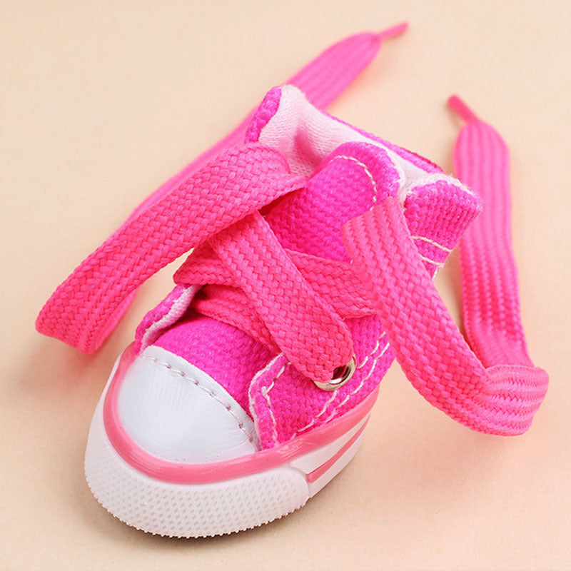 Close-up of bright pink mini canvas dog sneaker with thick matching pink laces