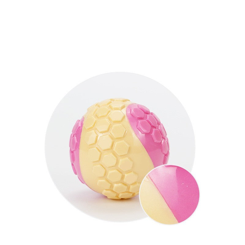 Detailed view of dual-color pink and beige dog chew ball surface