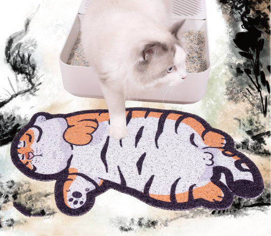 Cat stepping on fat tiger shaped PVC litter mat near cat litter box