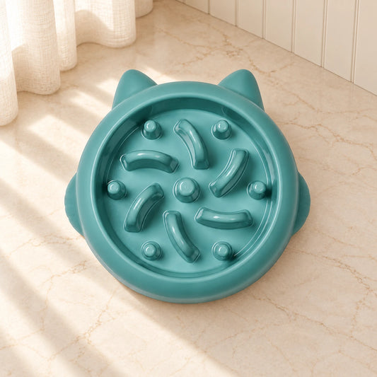 Green cat-ear slow feeder bowl with curved ridges and posts on beige marble
