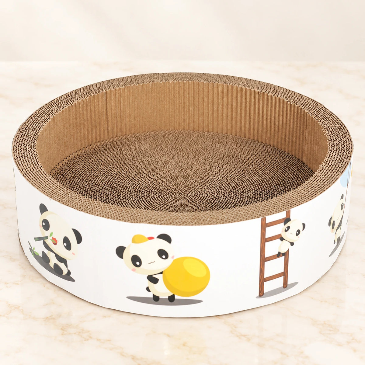 White panda-print corrugated cardboard cat scratcher bowl on ivory marble