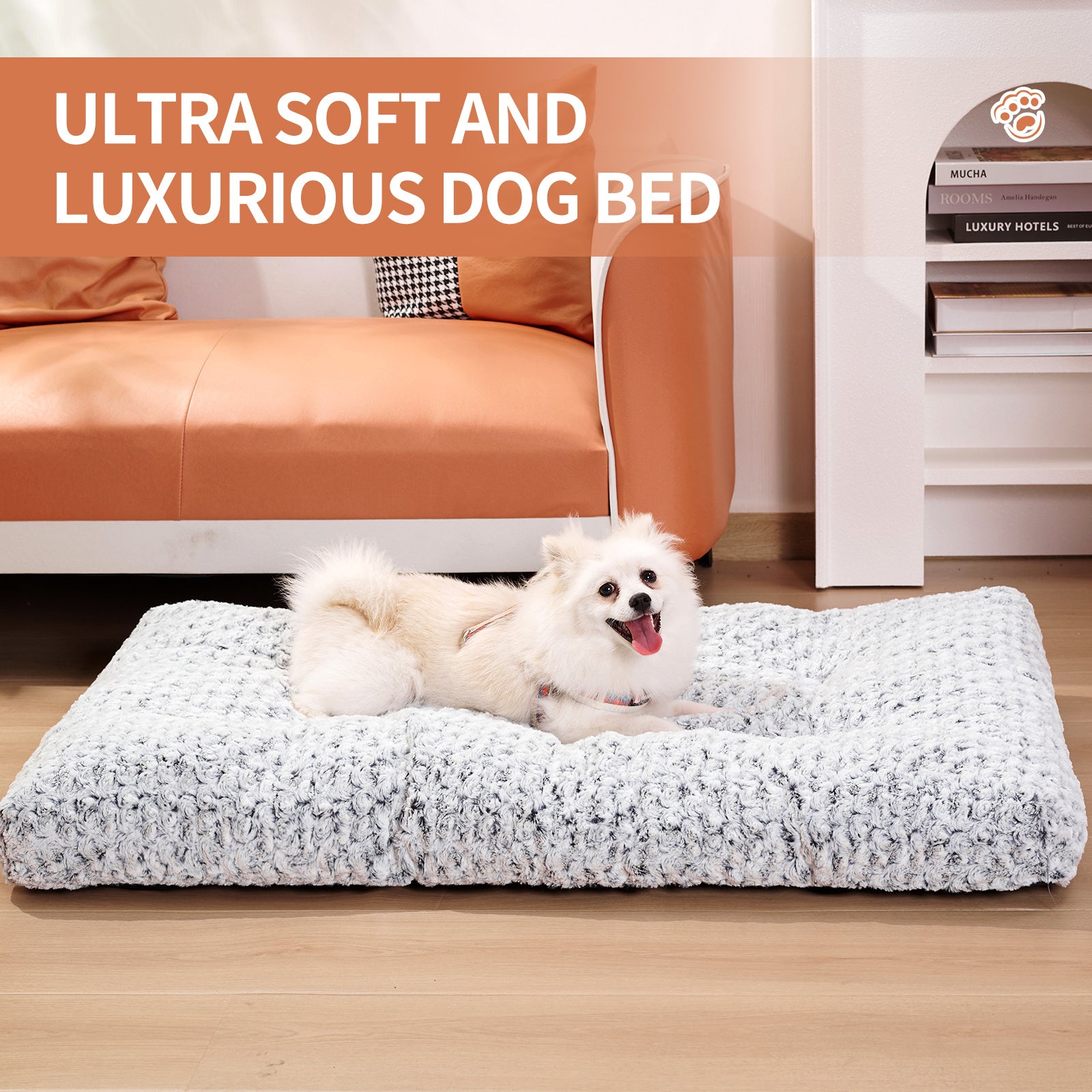 White fluffy dog lying on a thick, luxuriously soft light gray velvet dog bed near a brown couch with text highlighting ultra soft and luxurious features