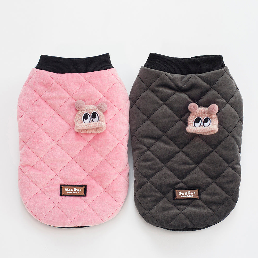 Front view of pink and charcoal gray quilted dog jackets with button closure displayed side by side on mannequins