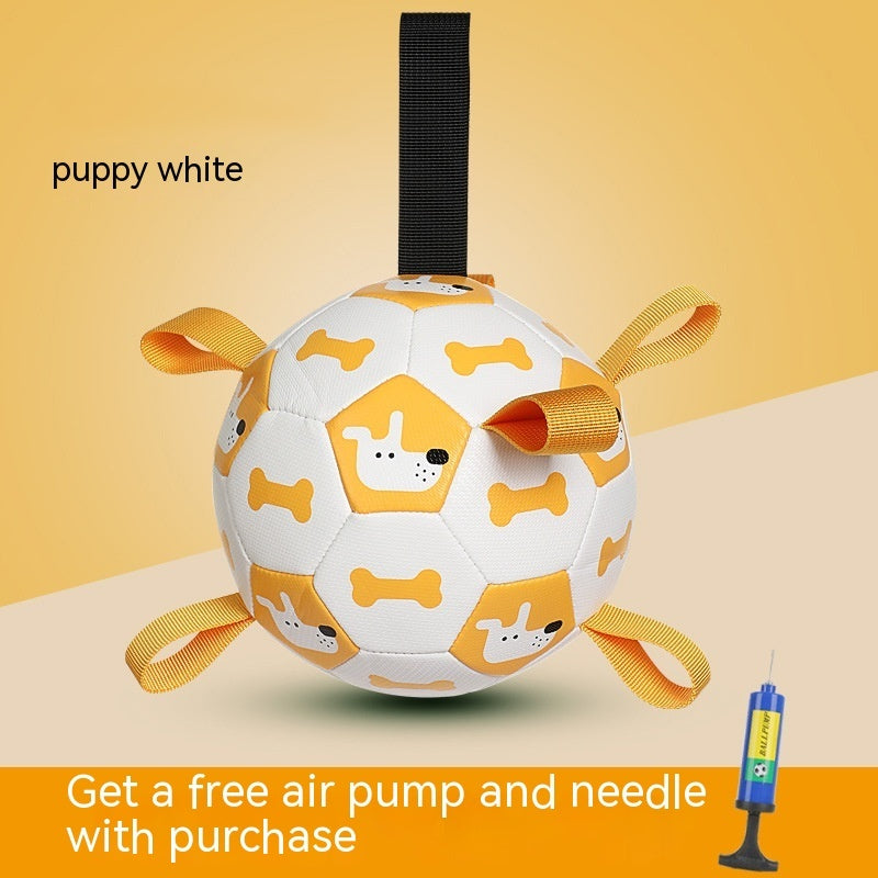 White and yellow inflatable dog toy ball with dog and bone prints and orange loops alongside a free air pump