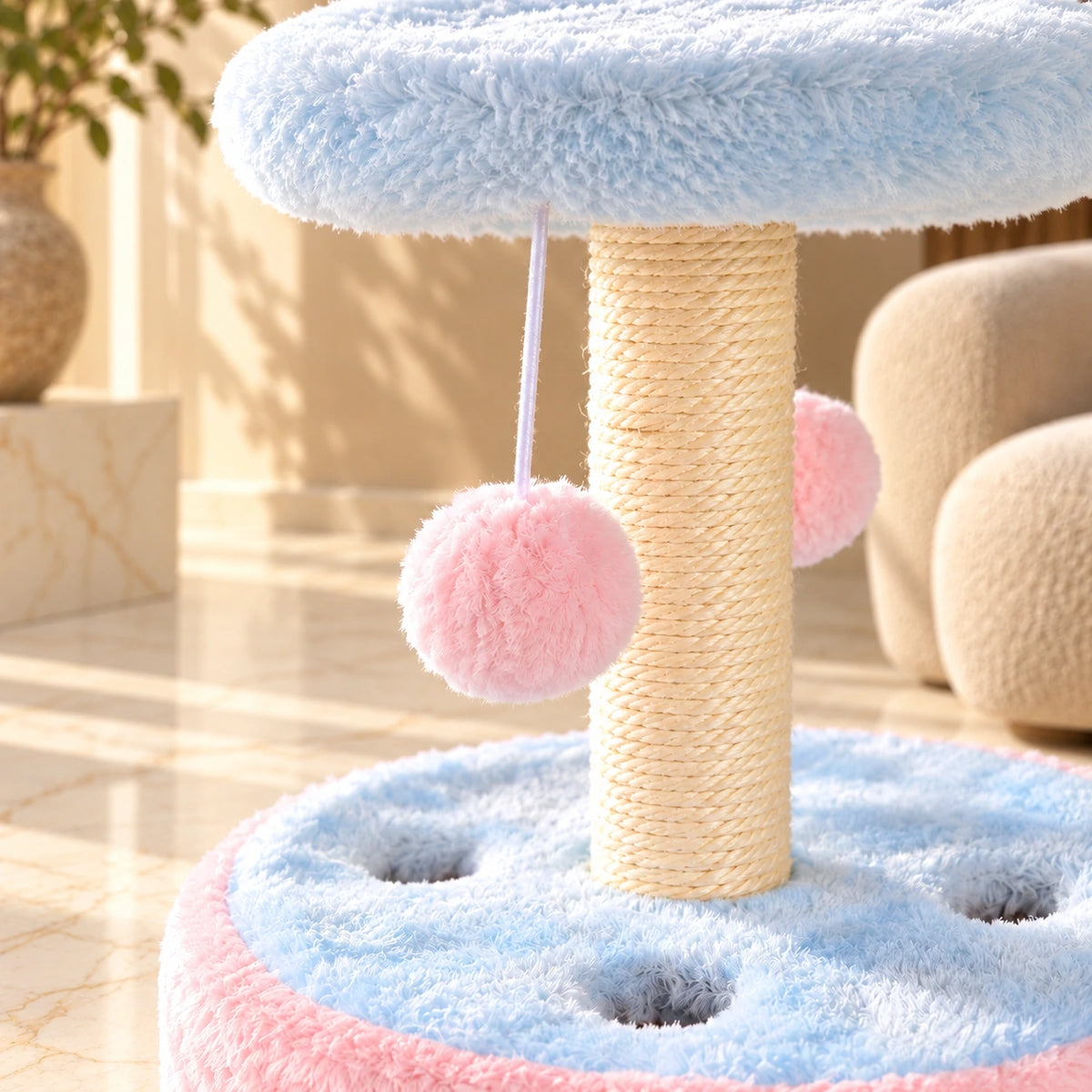 Close-up of sisal scratching rope, pink hanging pom-pom and blue plush cat play base.