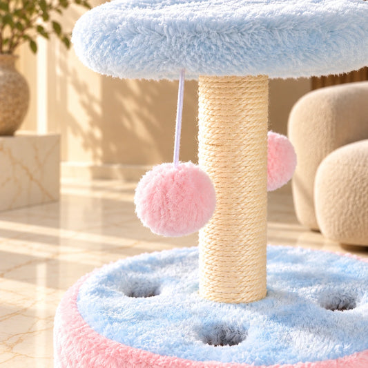 Close-up of sisal scratching rope, pink hanging pom-pom and blue plush cat play base.