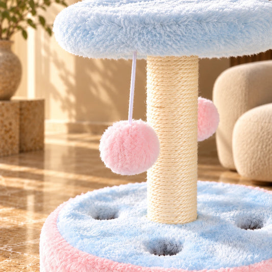 Close-up of sisal scratching rope, pink hanging pom-pom and blue plush cat play base.