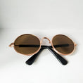 Load image into Gallery viewer, Round pet sunglasses with brown lenses and rose gold frame angled for style  
