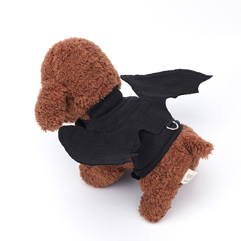 Side view of brown plush toy dog wearing black bat wing harness emphasizing wing shape and leash ring