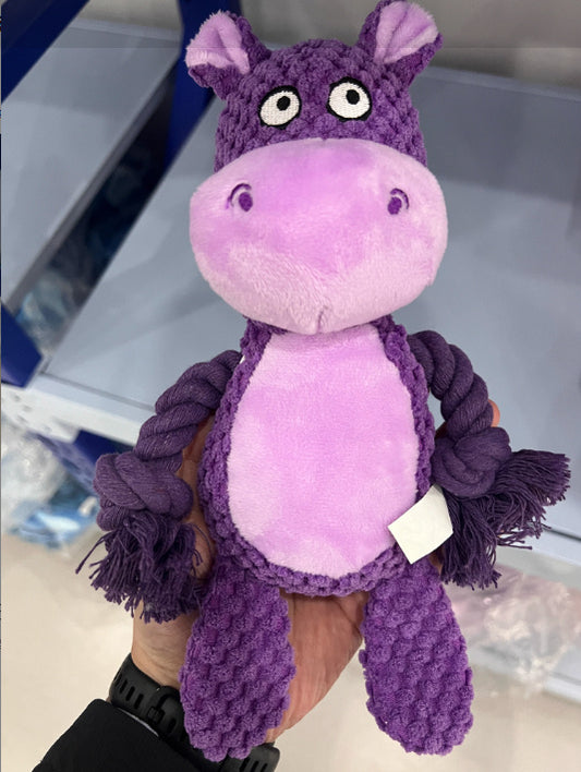Hand holding a purple hippo plush rope dog toy with textured plush and rope arms