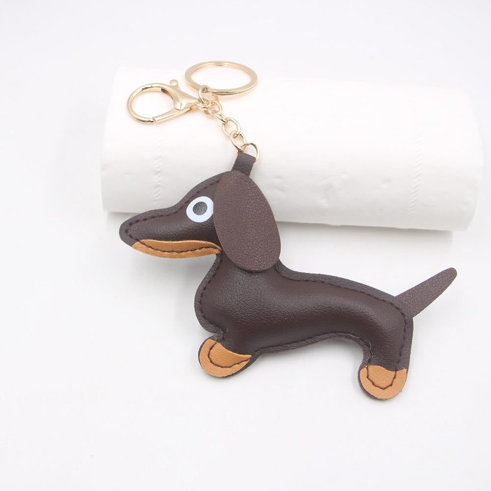 Brown faux leather sausage dog keychain on white background