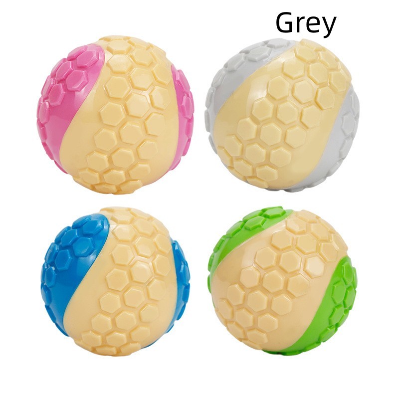 Four colored dog chew balls featuring gray, pink, green, and blue with honeycomb texture