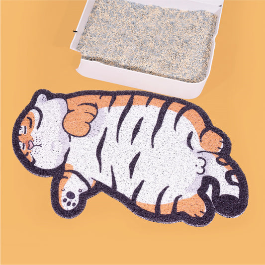 Close-up of fat tiger design PVC litter mat with litter box on orange background
