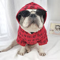 Charger l'image dans la visionneuse de la galerie, Bulldog wearing red hoodie and black oval sunglasses, sitting on white surface
