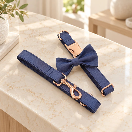 Indigo denim dog collar, bow and matching leash with rose-gold hardware on pale cream marble