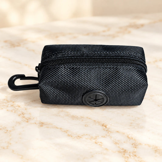 Black unlabelled zip waste-bag pouch with black clip and round dispensing port