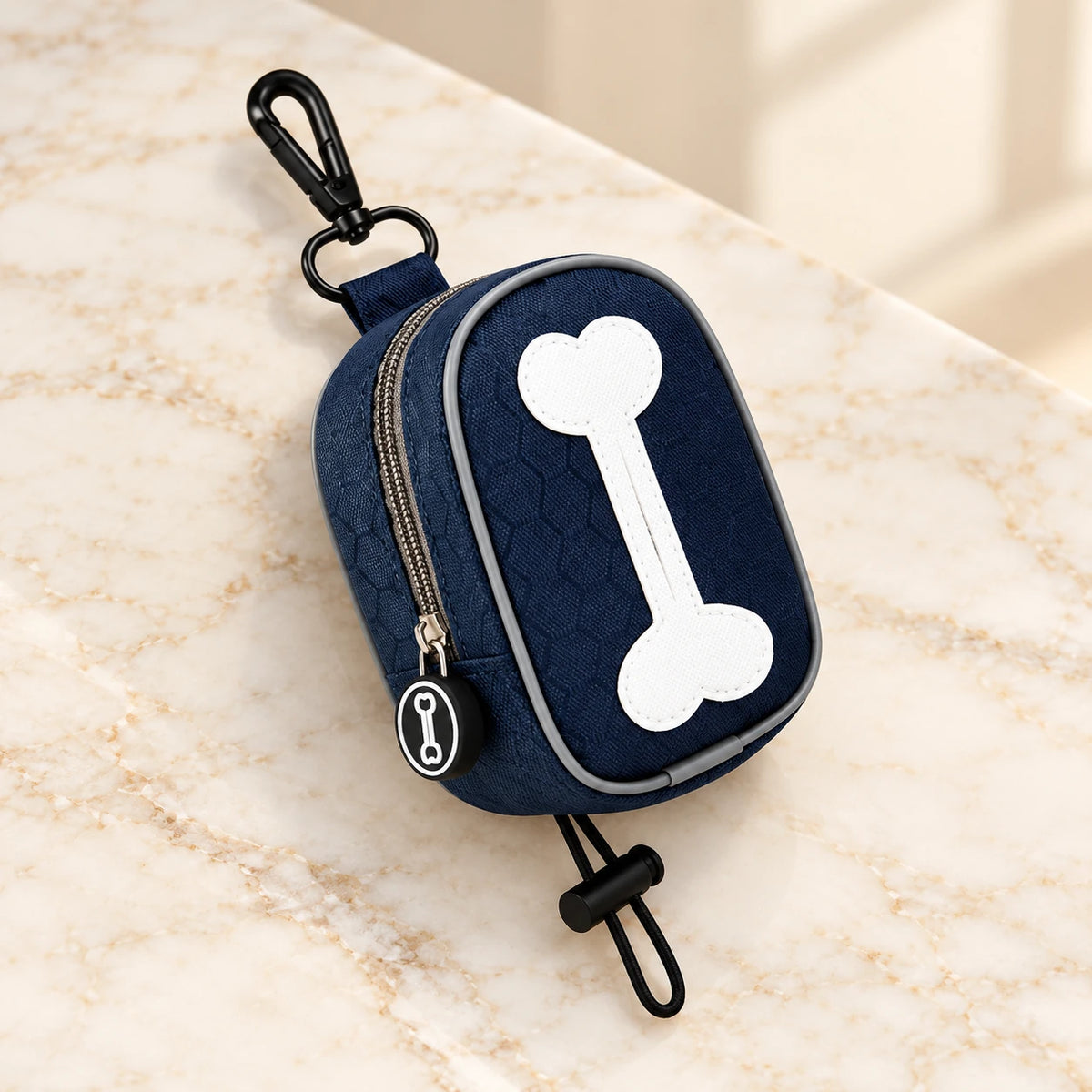 Dark-blue bone-design waste-bag pouch with white bone motif, clip and toggle loop