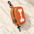 Cargar la imagen en la vista de la galería, Orange bone-design waste-bag pouch with white bone motif, clip and toggle loop
