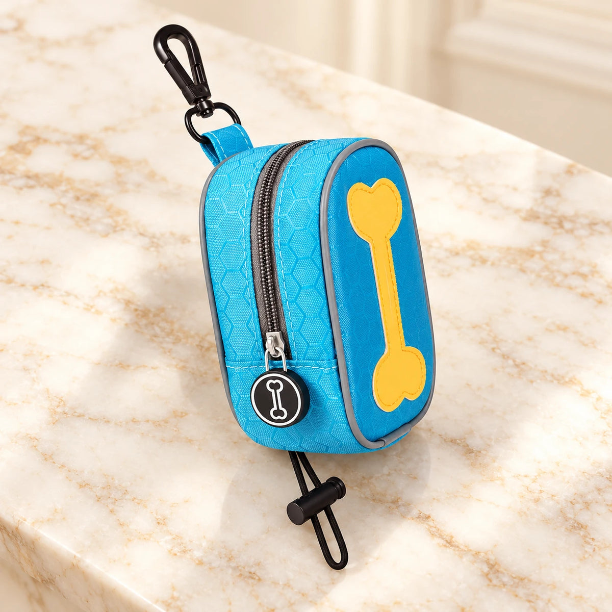 Sky-blue bone-design waste-bag pouch with yellow bone motif, clip and toggle loop